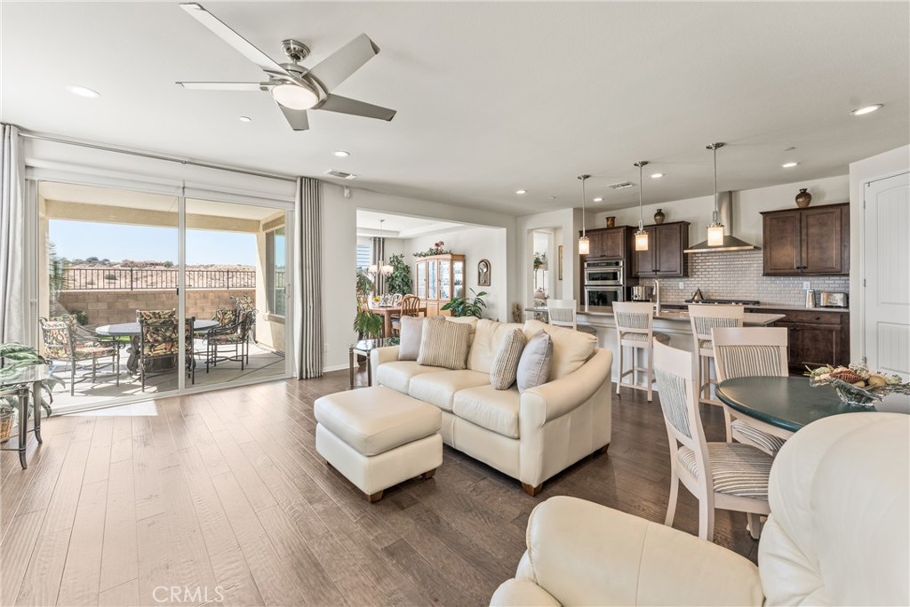 11636 Cascade Street Apple Valley, CA 92308 - Photo 10 of 70 a living room with furniture and a large window with kitchen view