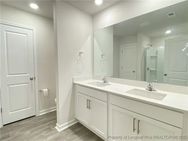 a bathroom with a double vanity sink and mirror
