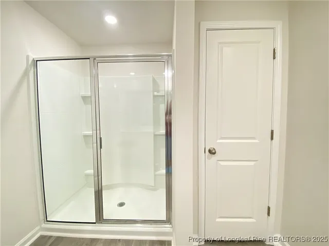 a bathroom with a glass shower door