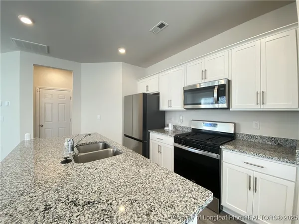 a kitchen with a sink stove and refrigerator