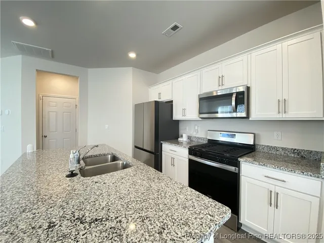 a kitchen with a sink stove and refrigerator