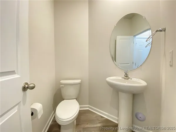 a bathroom with a toilet a sink and mirror