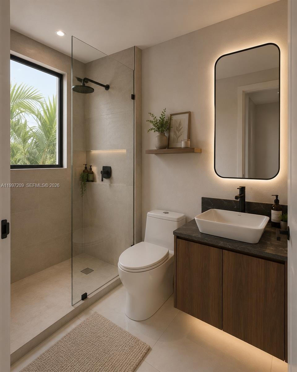 5912 Southwest 33rd Street Miami, FL 33155 - Photo 10 of 16 a bathroom with a toilet sink and mirror