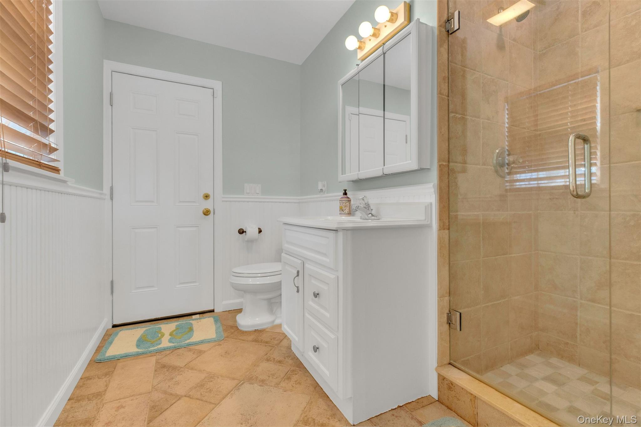345 Colonial Road Southold, NY 11971 - Photo 19 of 43 a bathroom with a sink a toilet and shower