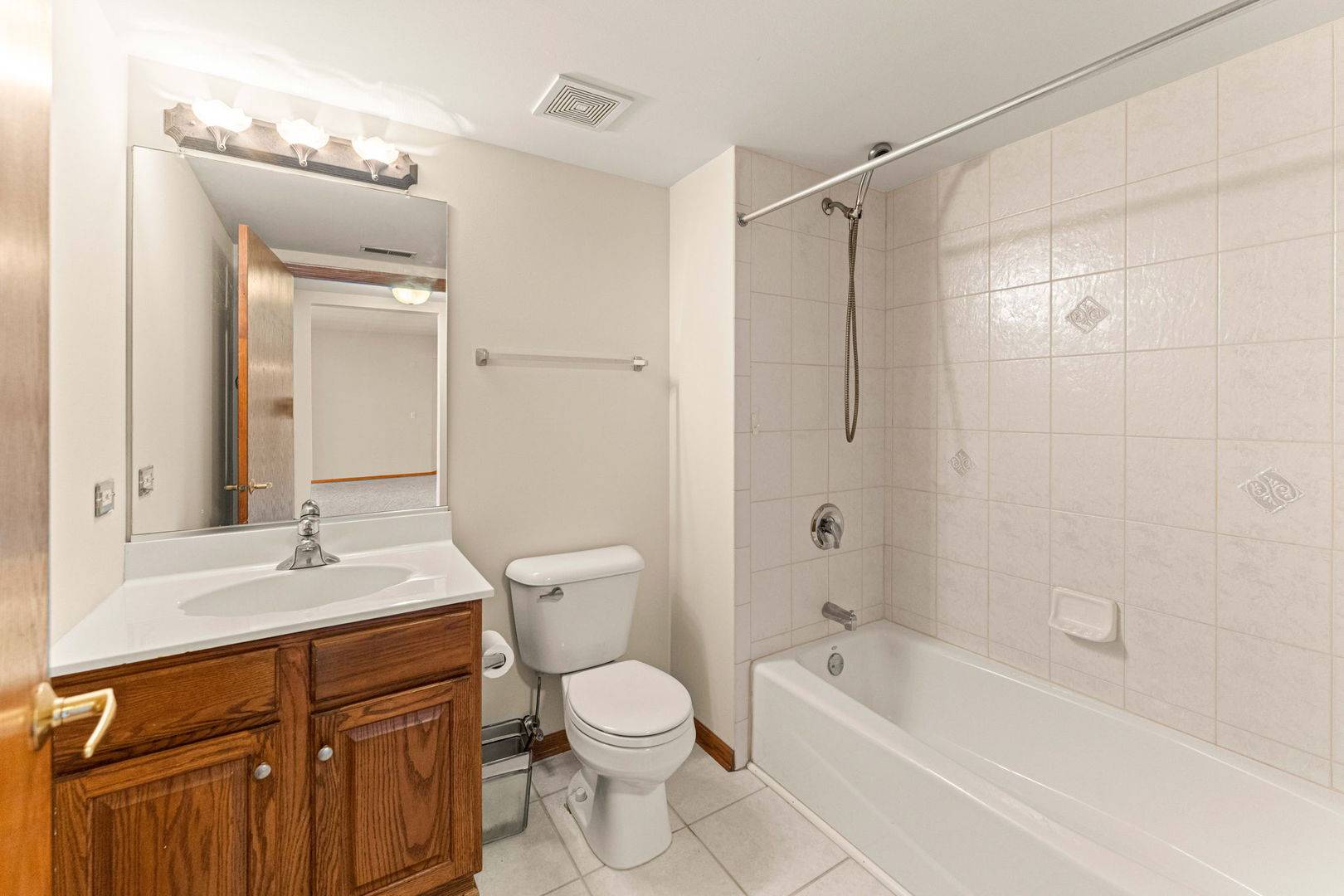 11901 Windemere Court, Unit 301 Orland Park, IL 60467 - Photo 13 of 27 a bathroom with a granite countertop sink a toilet a mirror and shower