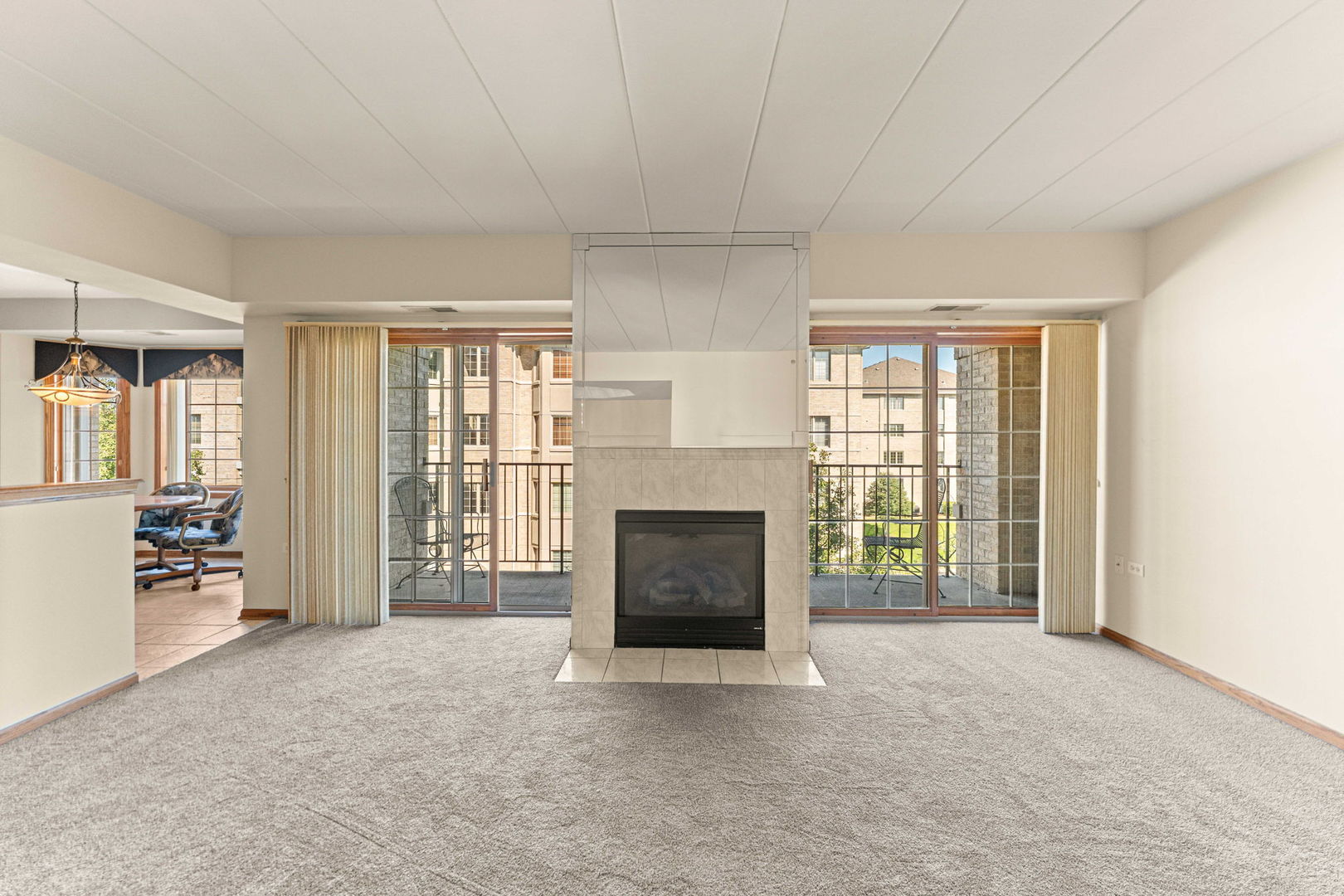 11901 Windemere Court, Unit 301 Orland Park, IL 60467 - Photo 14 of 27 an empty room with furniture and a fireplace