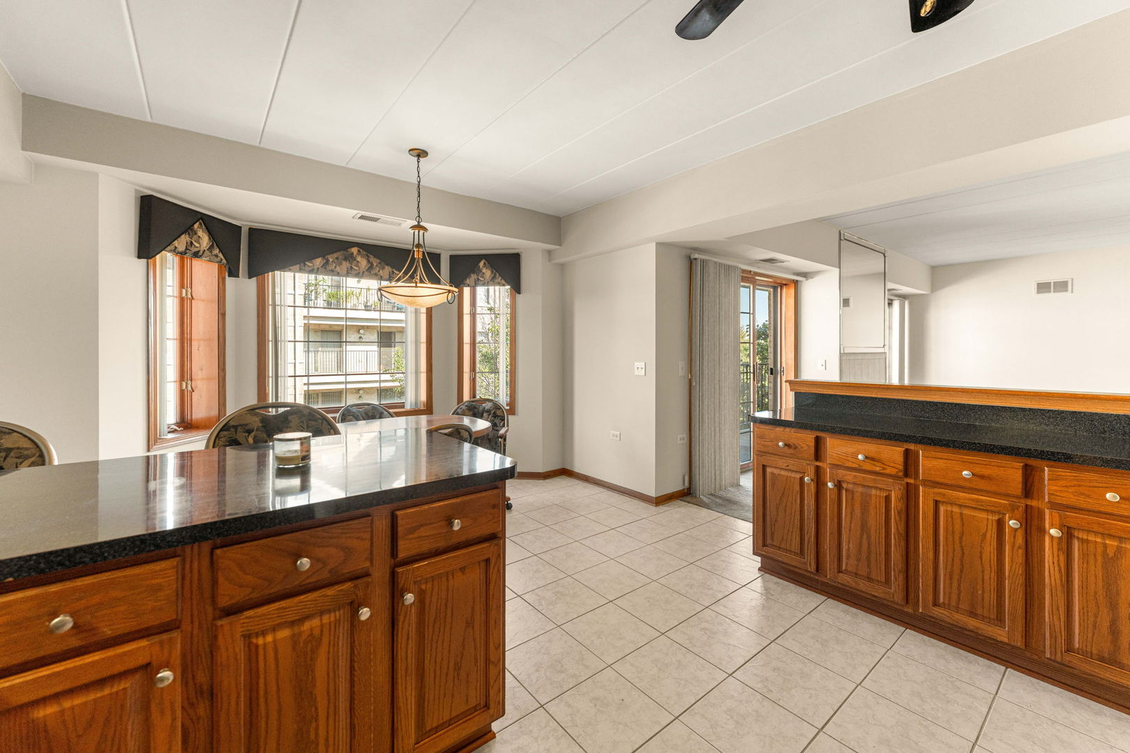 11901 Windemere Court, Unit 301 Orland Park, IL 60467 - Photo 17 of 27 a kitchen with stainless steel appliances granite countertop a sink and cabinets