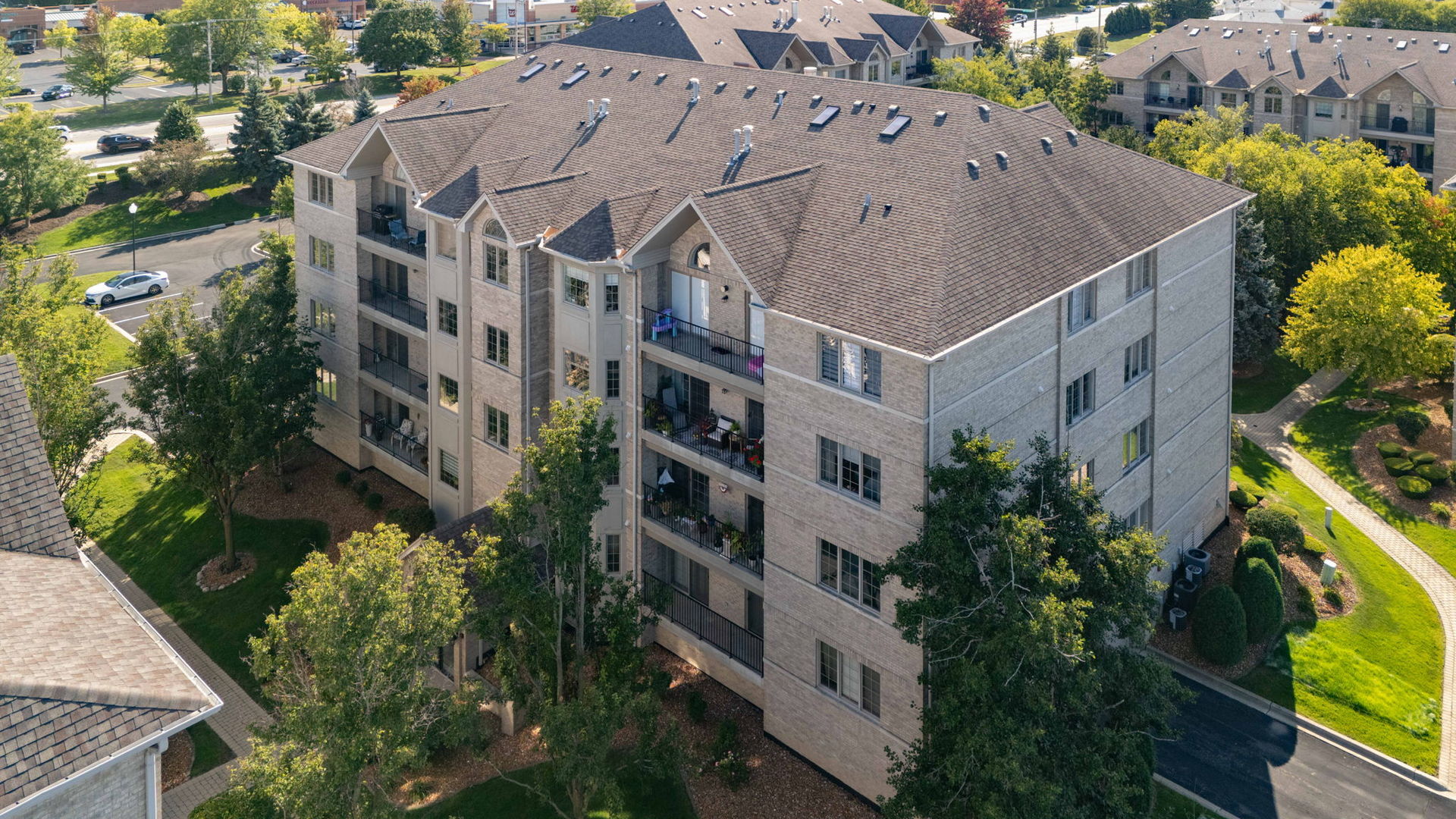 11901 Windemere Court, Unit 301 Orland Park, IL 60467 - Photo 27 of 27 an aerial view of multiple houses with a yard