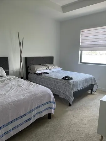 a bedroom with bed and window