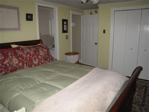 50 Grapevine Road Gloucester, MA 01930 - Photo 8 of 9 a bedroom with a bed and painting on the wall