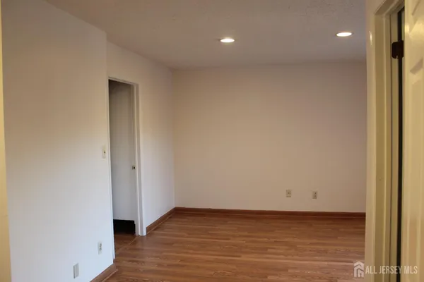 a view of a room with wooden floor and a window