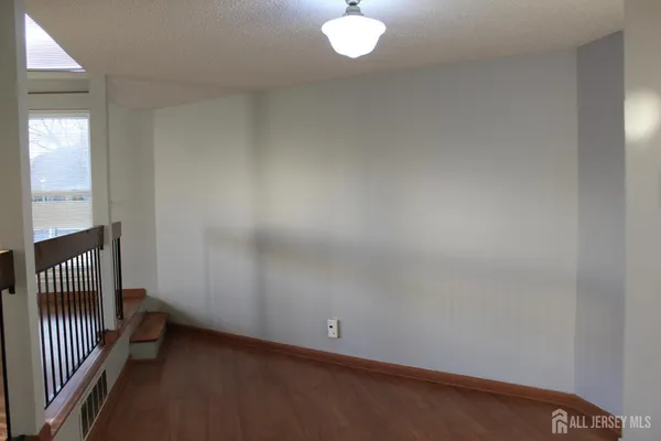 a view of a house with a yard and a car park