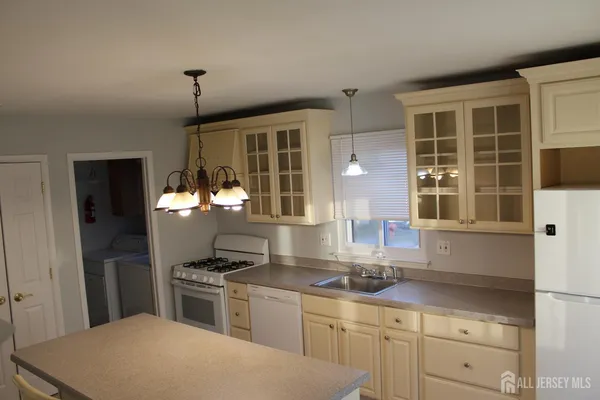 a kitchen that has a lot of cabinets and wooden floor