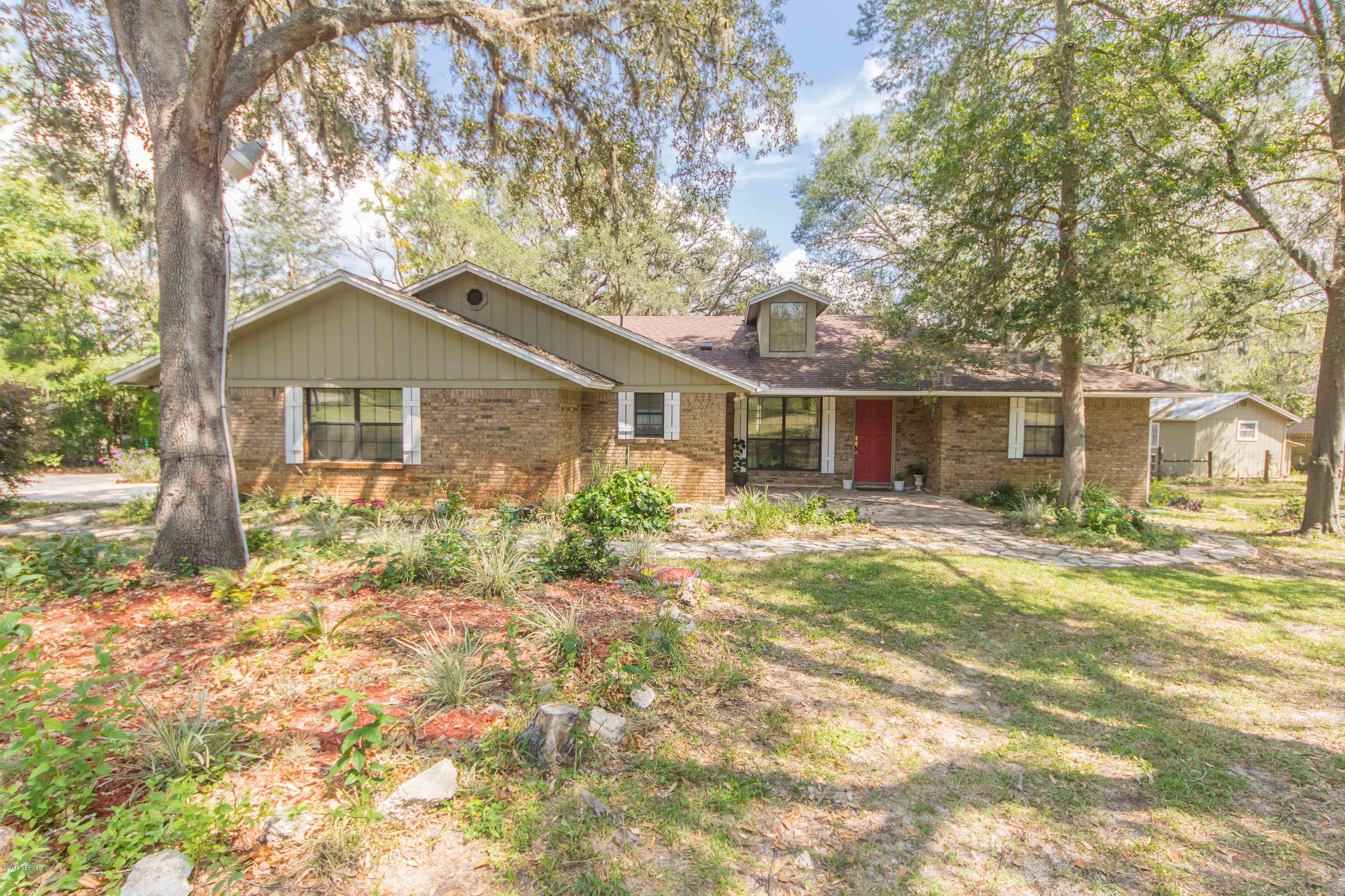 6255 Little Lake Geneva Road Keystone Heights, FL 32656 - Photo 1 of 59 a front view of a house with a yard and trees