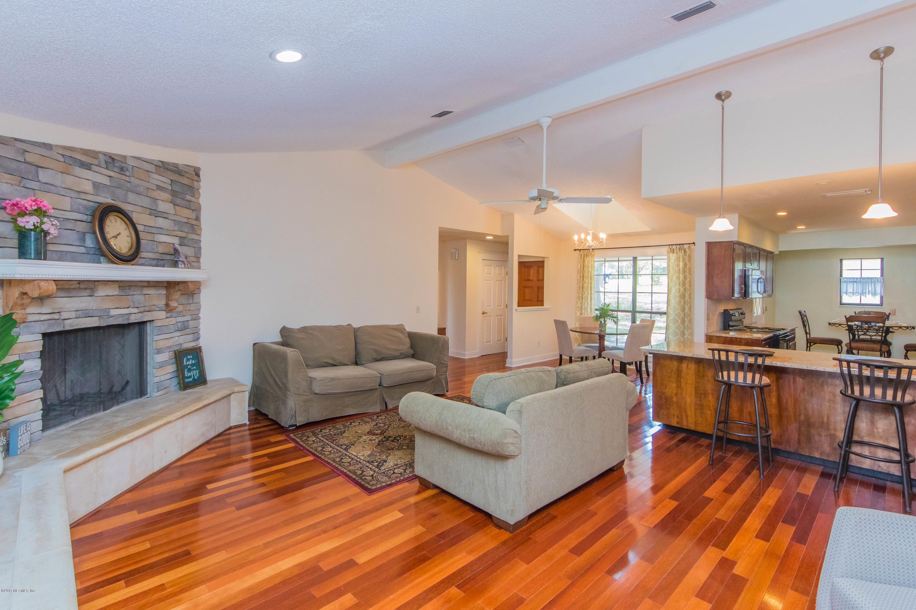 6255 Little Lake Geneva Road Keystone Heights, FL 32656 - Photo 12 of 59 a living room with furniture a fireplace and a table