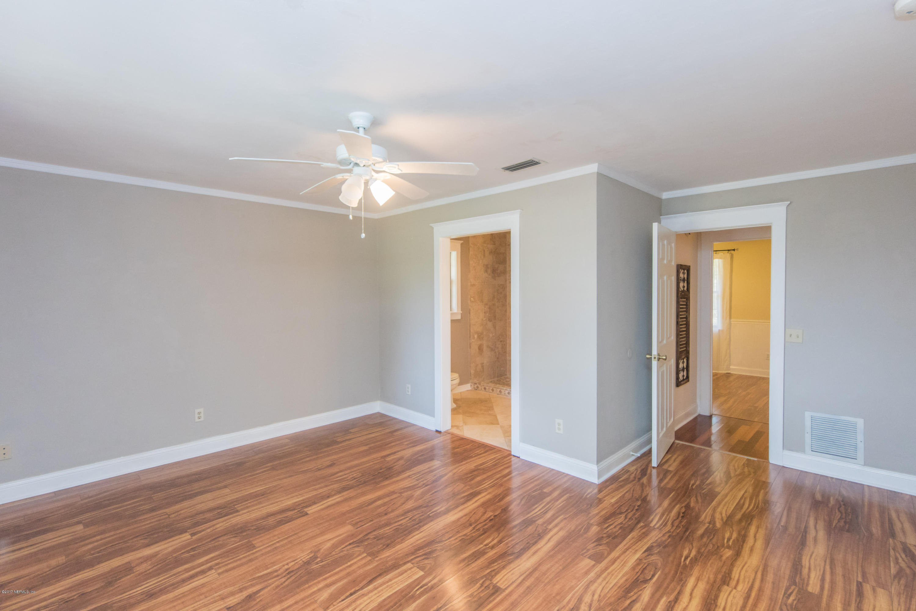 6255 Little Lake Geneva Road Keystone Heights, FL 32656 - Photo 25 of 59 an empty room with wooden floor and a ceiling fan