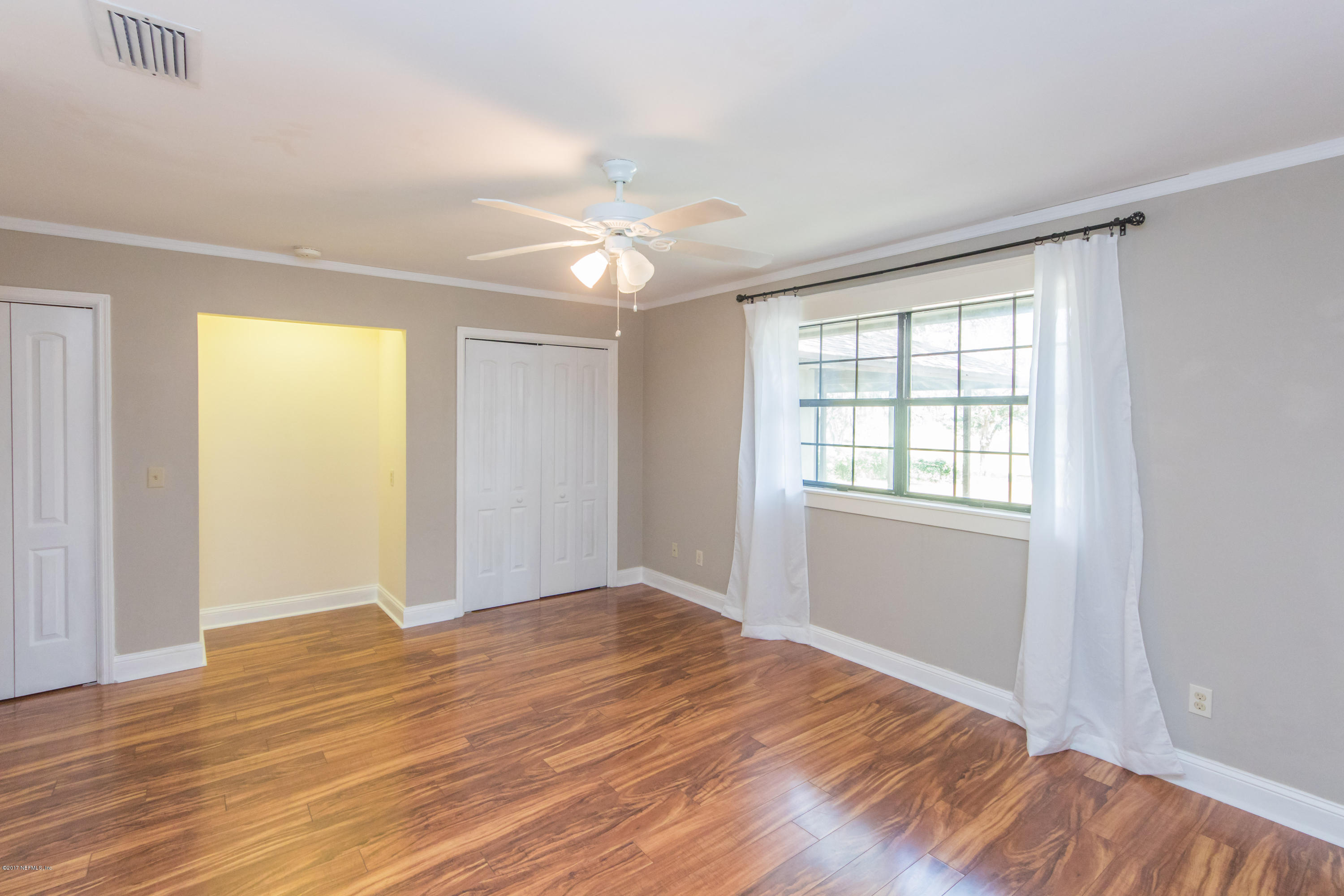 6255 Little Lake Geneva Road Keystone Heights, FL 32656 - Photo 27 of 59 a view of empty room with wooden floor and fan