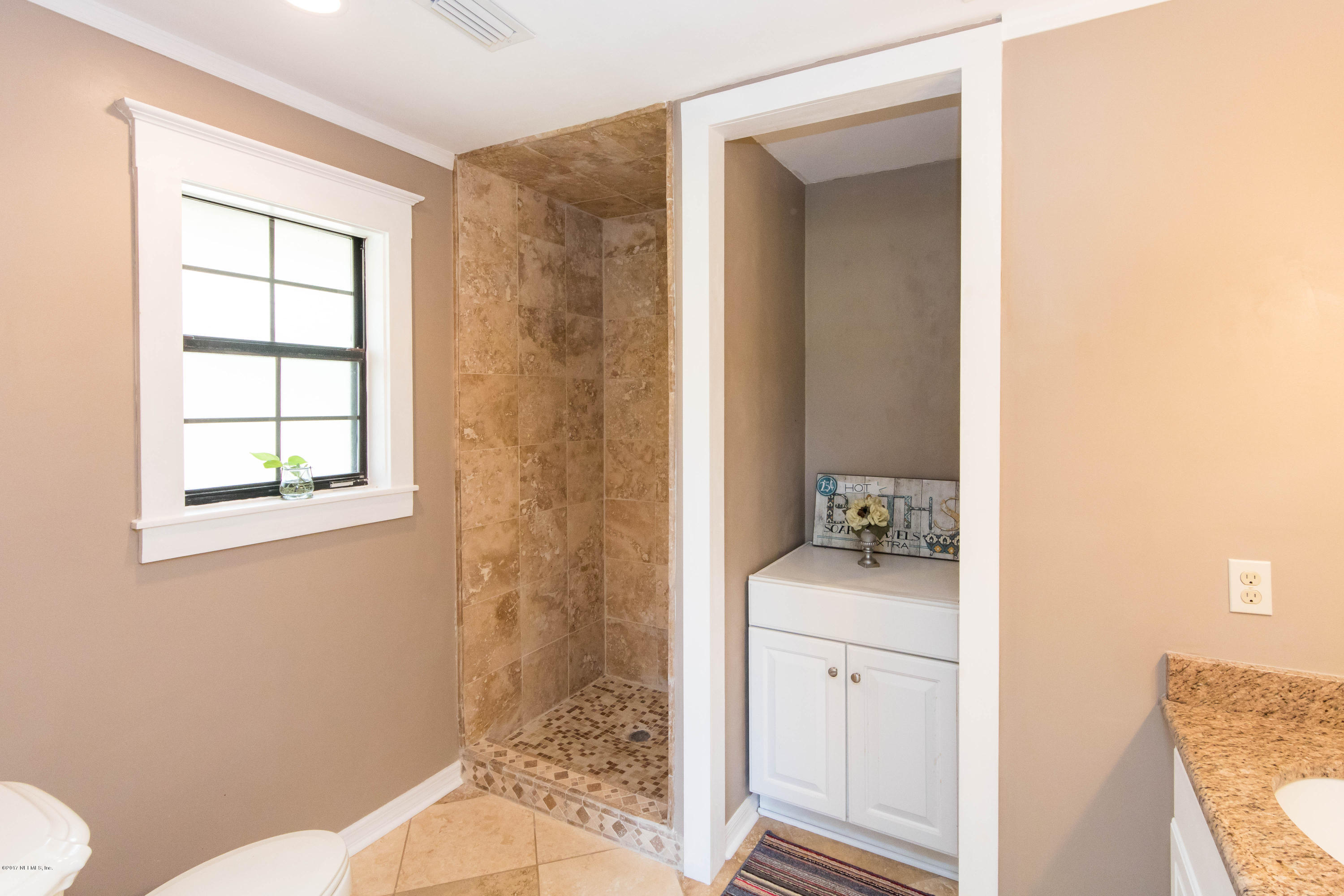 6255 Little Lake Geneva Road Keystone Heights, FL 32656 - Photo 29 of 59 a bathroom with a sink toilet and window