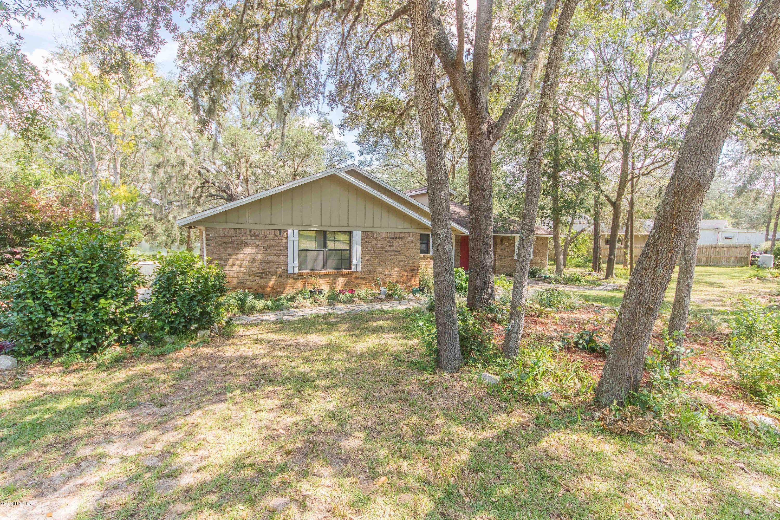 6255 Little Lake Geneva Road Keystone Heights, FL 32656 - Photo 3 of 59 a front view of a house with a garden