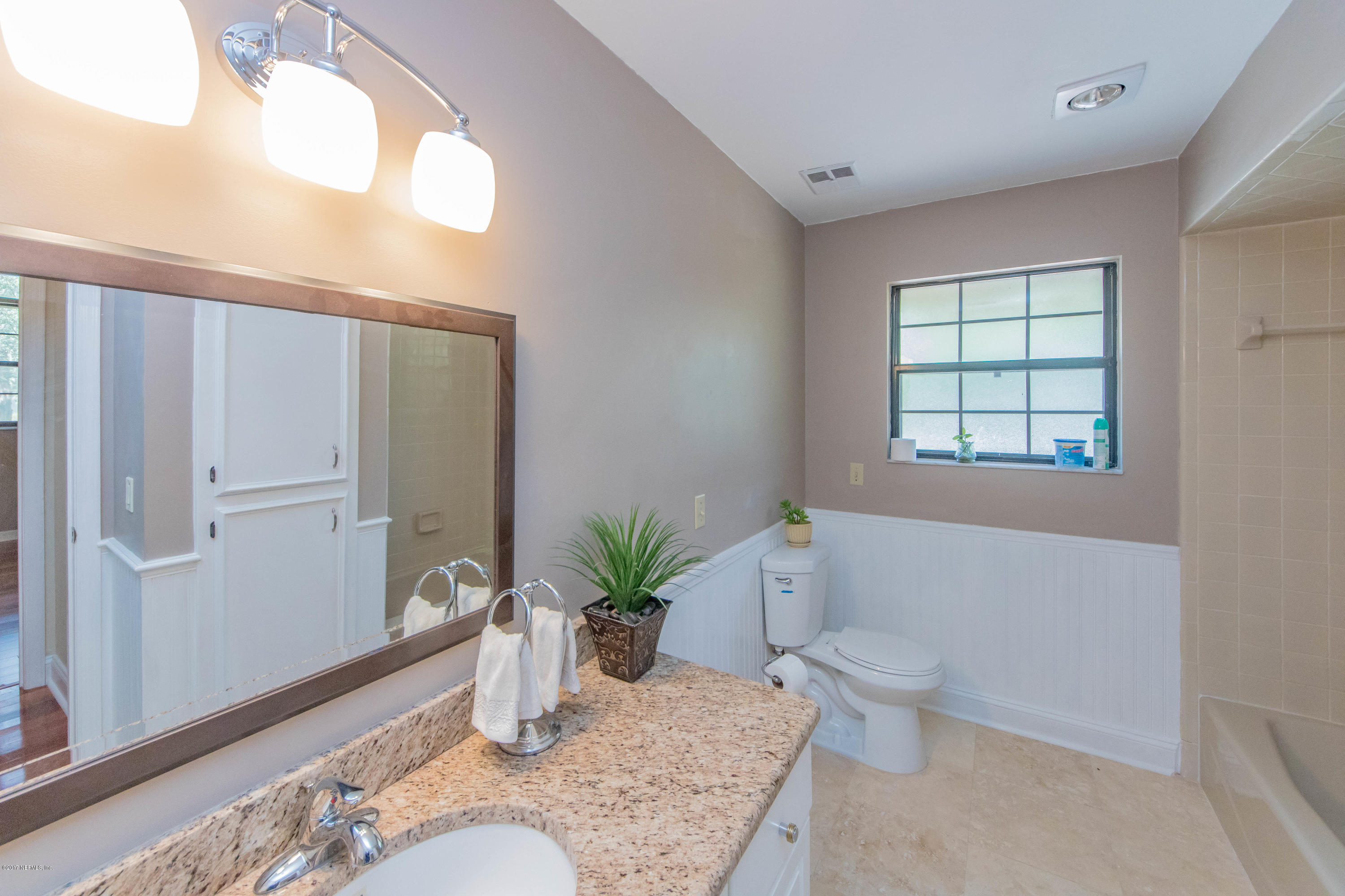 6255 Little Lake Geneva Road Keystone Heights, FL 32656 - Photo 33 of 59 a bathroom with a granite countertop sink a toilet and tub