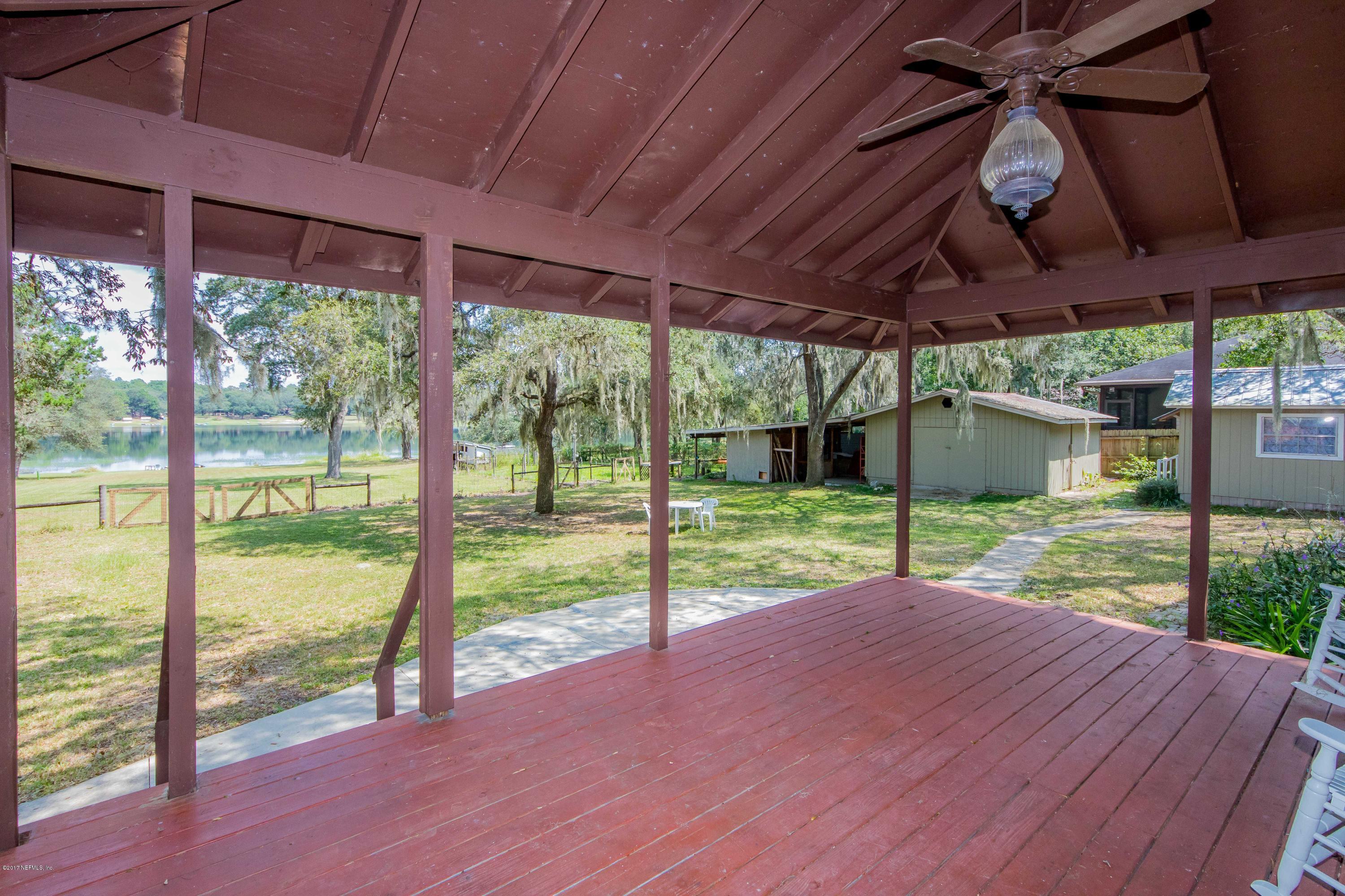 6255 Little Lake Geneva Road Keystone Heights, FL 32656 - Photo 34 of 59 a view of a house with backyard and porch