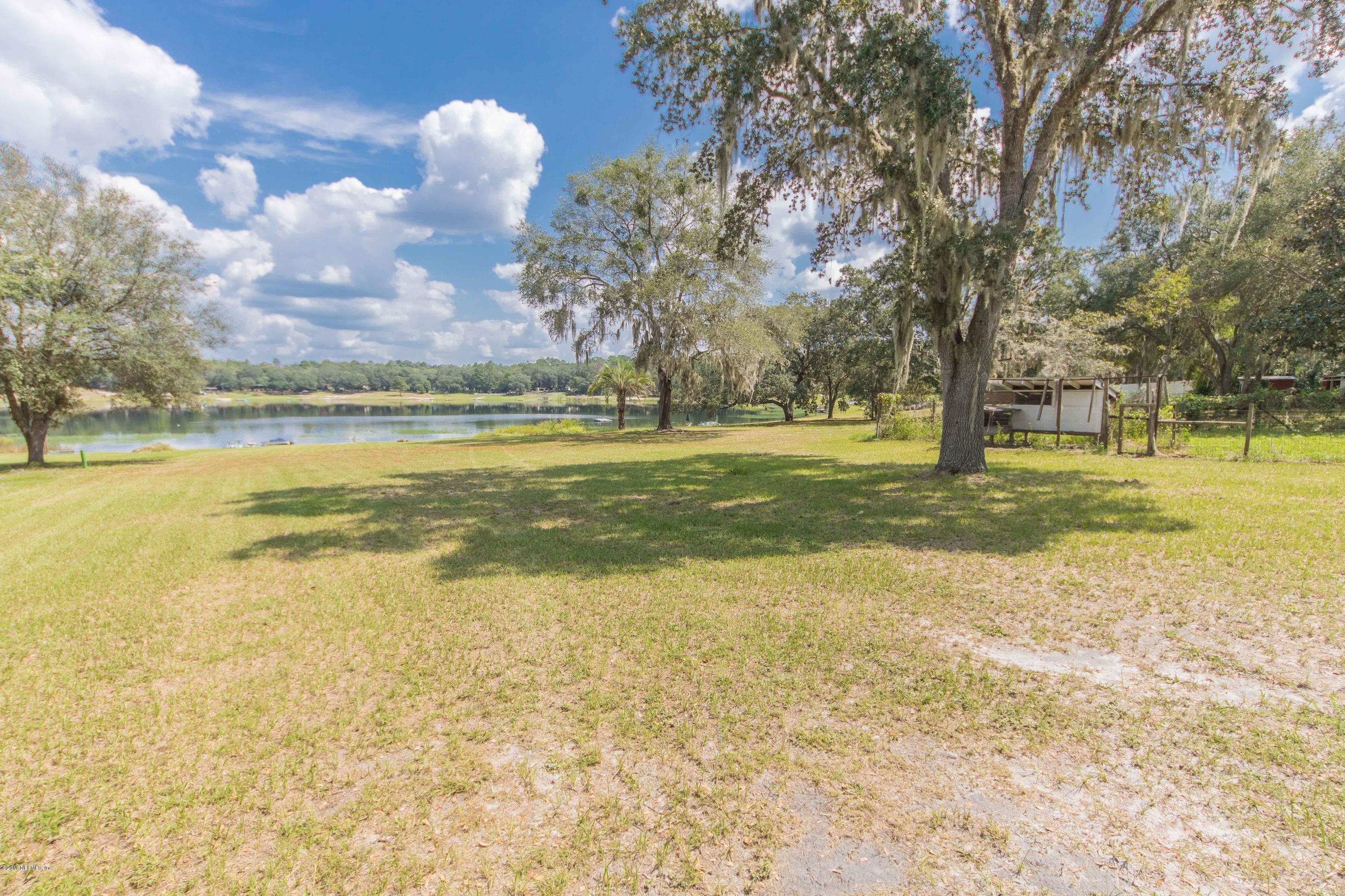 6255 Little Lake Geneva Road Keystone Heights, FL 32656 - Photo 43 of 59 a view of a swimming pool with an outdoor space and seating area