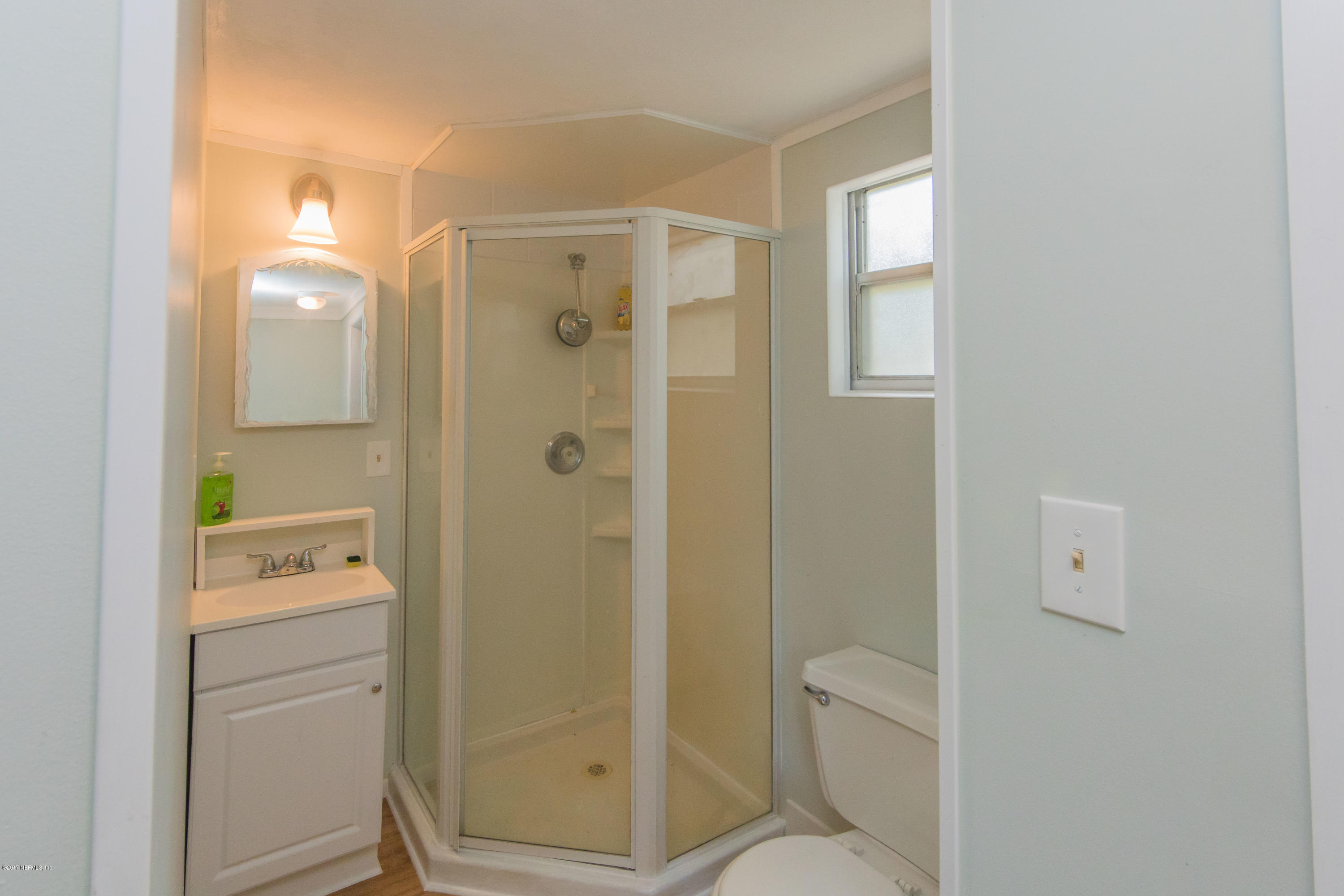 6255 Little Lake Geneva Road Keystone Heights, FL 32656 - Photo 53 of 59 a bathroom with a shower a toilet and a sink
