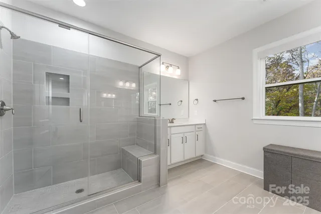 a bathroom with a granite countertop sink a toilet and shower