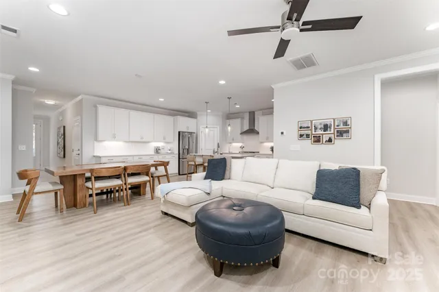 a living room with furniture and kitchen view