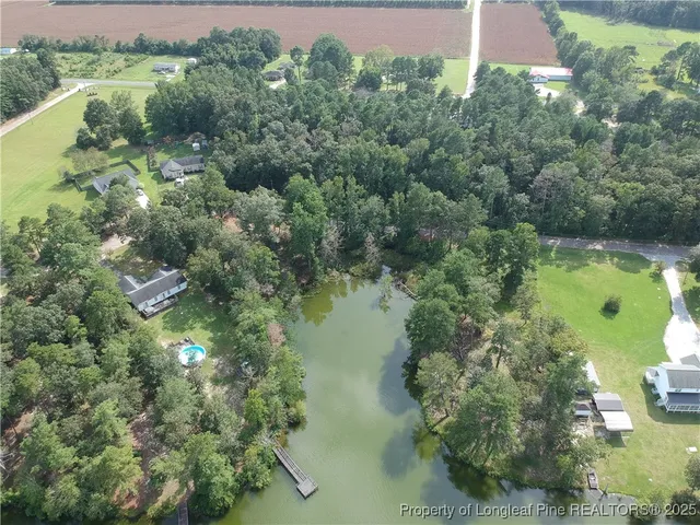 an aerial view of lake yard swimming pool and outdoor seating
