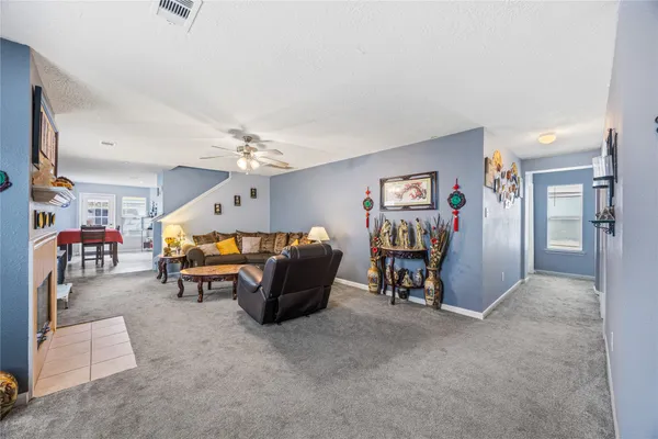 a view of livingroom with furniture and chandelier fan