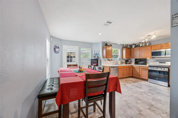 a kitchen with a refrigerator and a stove top oven