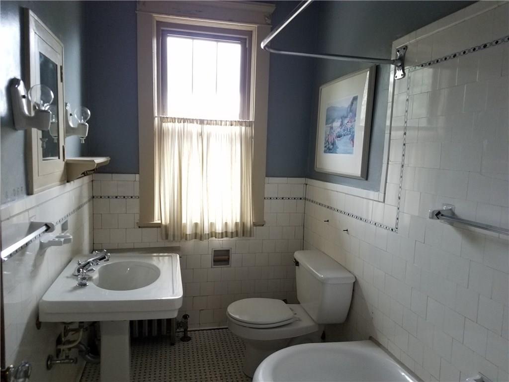 2619 Brighton Road Pittsburgh, PA 15212 - Photo 18 of 23 Main bath with classic original ceramic tile walls and floor and long deep tub. New window.