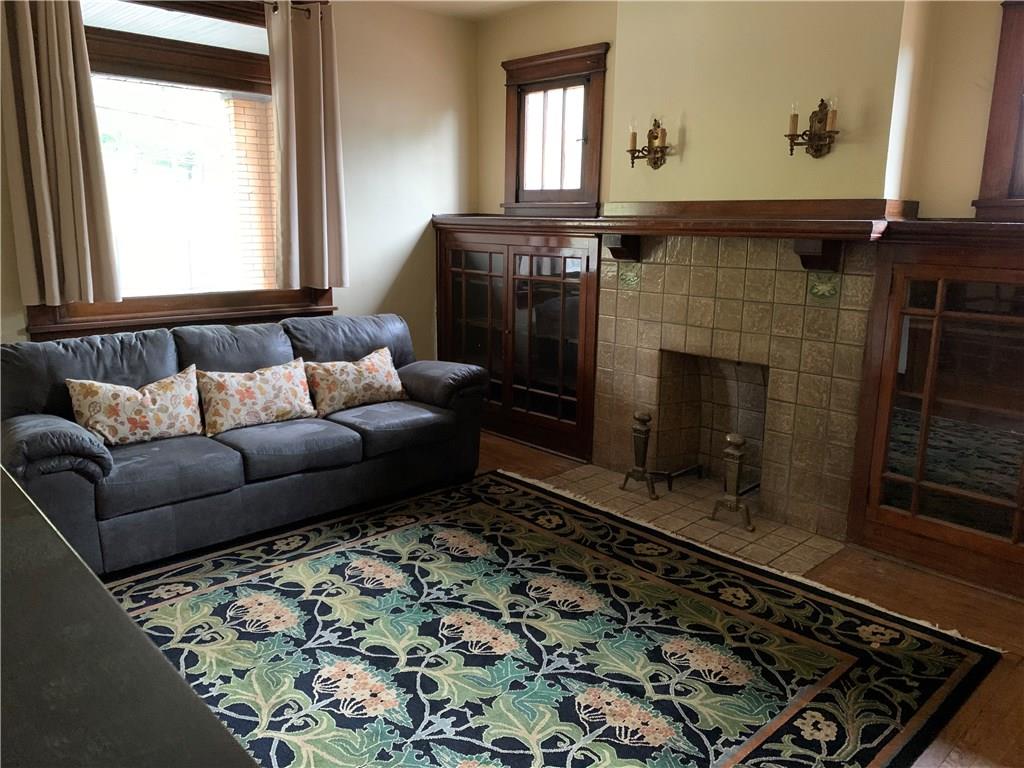 2619 Brighton Road Pittsburgh, PA 15212 - Photo 9 of 23 Living Room 15x13 with original ceramic tile fireplace and metal andirons with flanking glass front book/display cases with adjustable shelving.