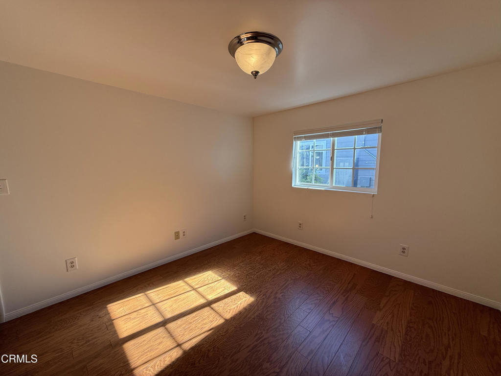 1775 Atchison Street Pasadena, CA 91104 - Photo 14 of 21 a view of an empty room with wooden floor and a window
