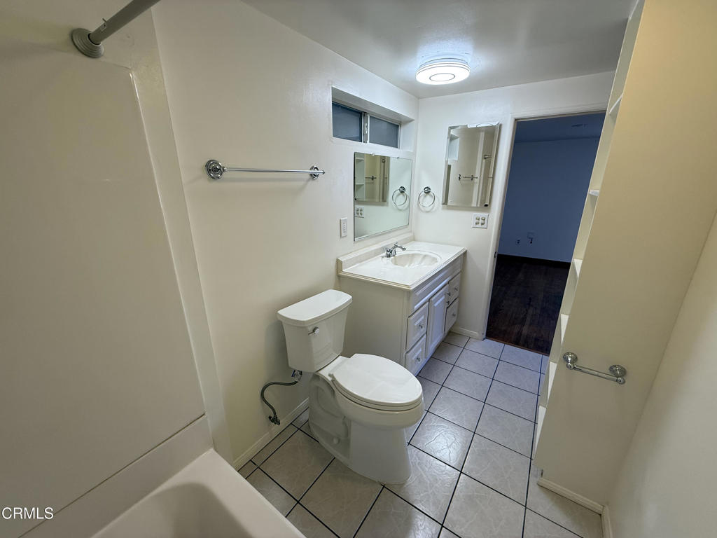 1775 Atchison Street Pasadena, CA 91104 - Photo 16 of 18 a bathroom with a toilet sink and mirror