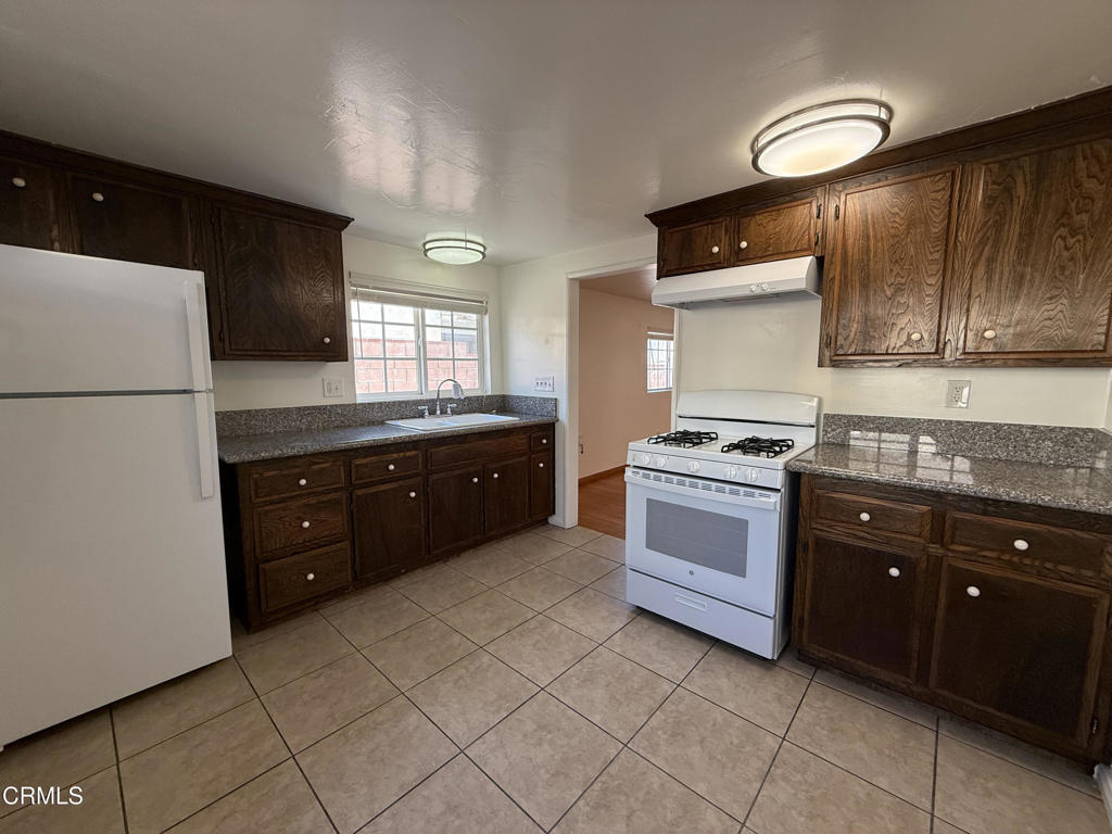 1775 Atchison Street Pasadena, CA 91104 - Photo 3 of 21 a kitchen with a cabinets and white appliances