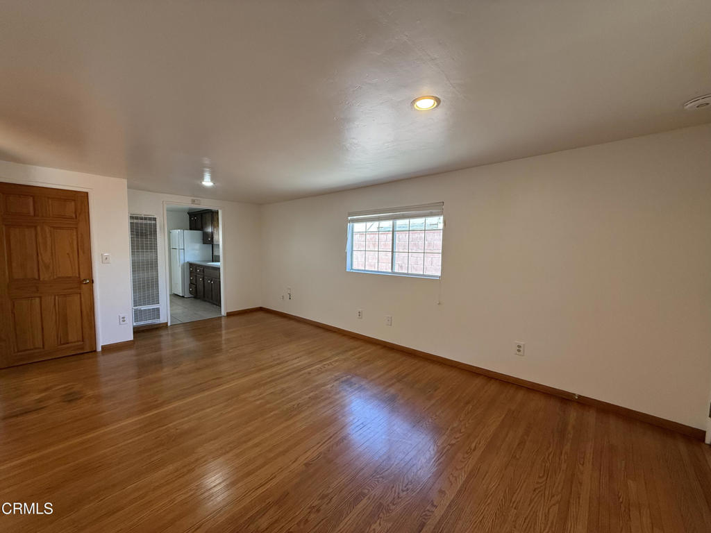 1775 Atchison Street Pasadena, CA 91104 - Photo 4 of 21 a view of an empty room with wooden floor and a window