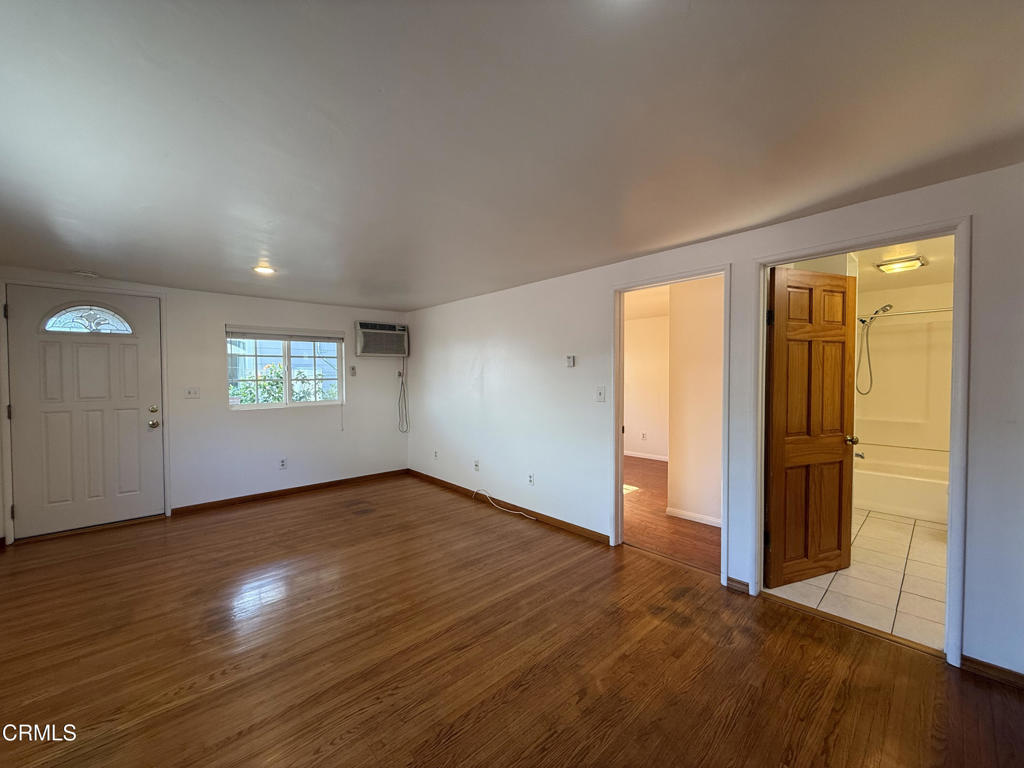 1775 Atchison Street Pasadena, CA 91104 - Photo 4 of 18 an empty room with wooden floor and windows