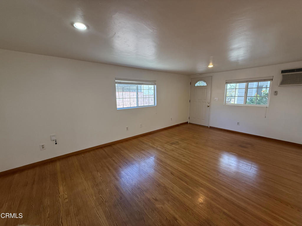 1775 Atchison Street Pasadena, CA 91104 - Photo 5 of 18 an empty room with wooden floor and windows