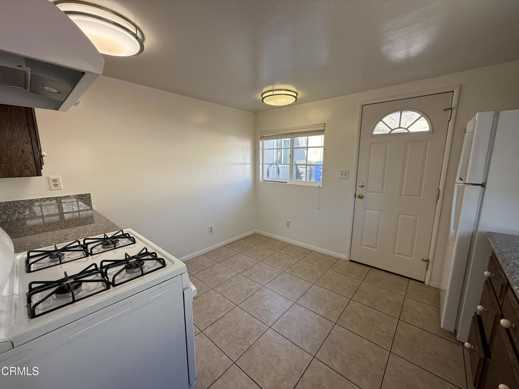 1775 Atchison Street Pasadena, CA 91104 - Photo 9 of 18 a kitchen with a stove and a refrigerator