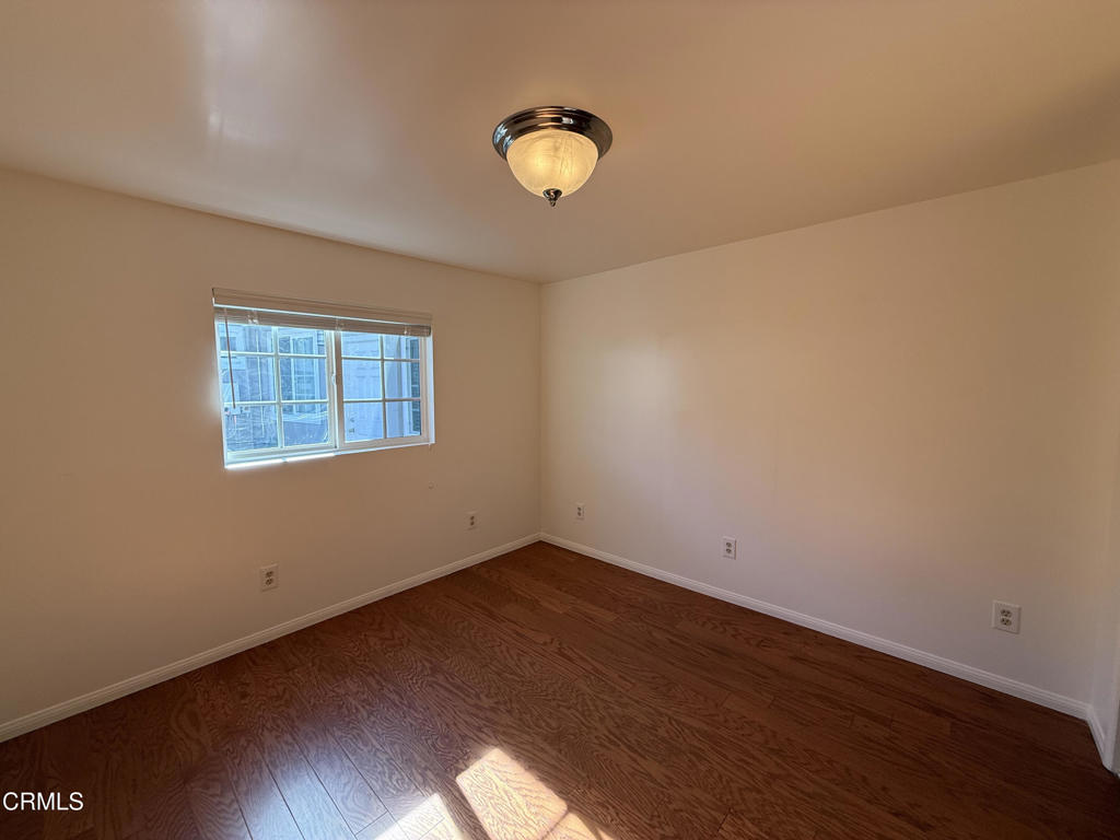 1775 Atchison Street Pasadena, CA 91104 - Photo 10 of 18 a view of an empty room with wooden floor and a window