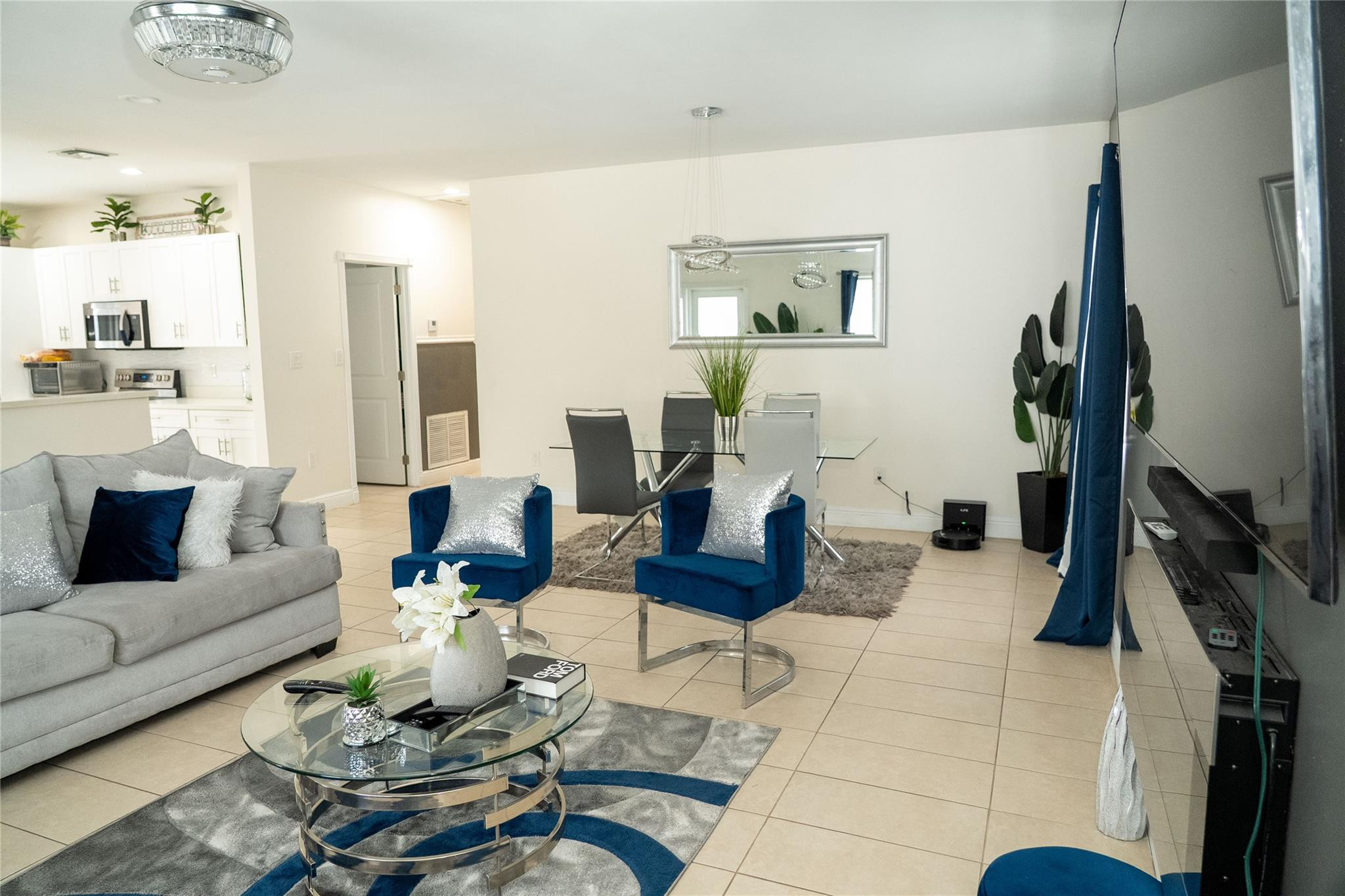 2710 Northwest 5th Street Pompano Beach, FL 33069 - Photo 4 of 31 a living room with furniture a rug and a flat screen tv