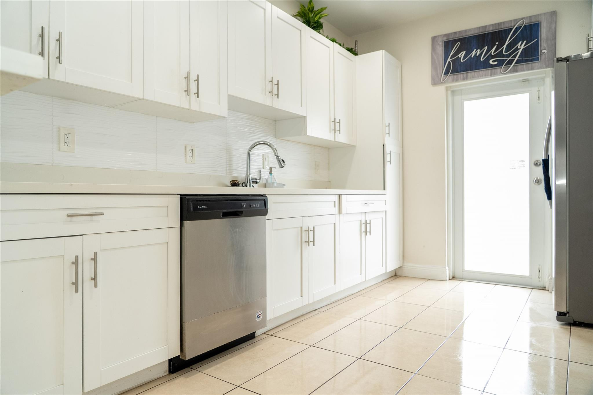 2710 Northwest 5th Street Pompano Beach, FL 33069 - Photo 8 of 31 a kitchen with a sink cabinets and appliances