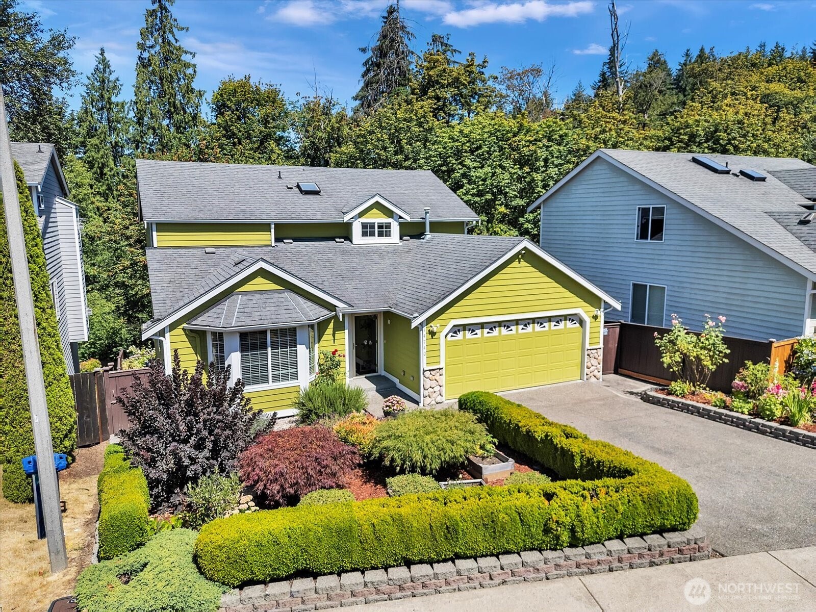 a front view of a house with a garden
