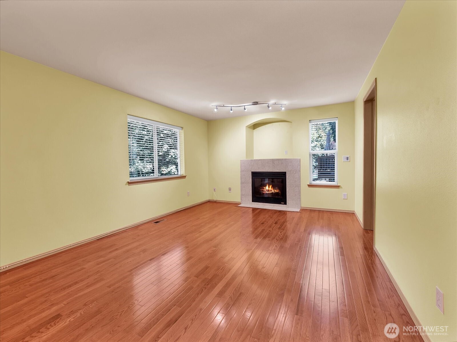 14740 Southeast 187 Court Renton, WA 98058 - Photo 12 of 38 a view of empty room with wooden floor and fireplace