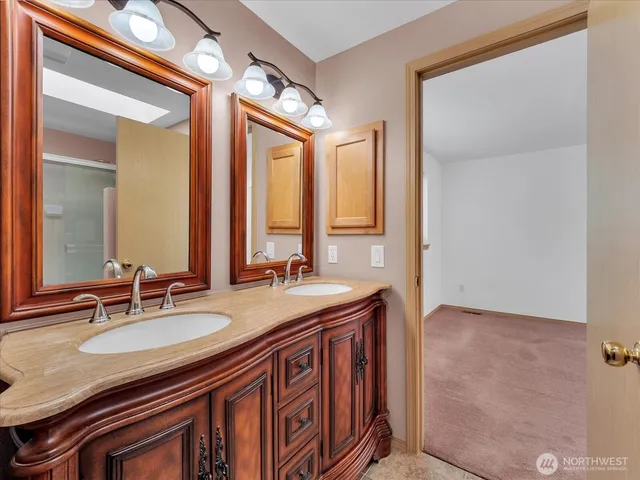 a bathroom with a sink double vanity and a mirror