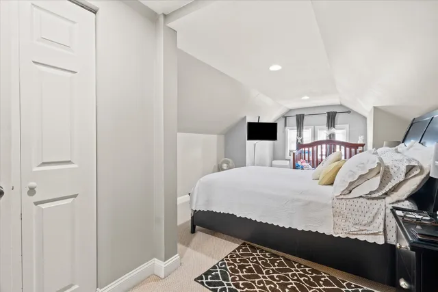 a bedroom with a bed and walk in closet