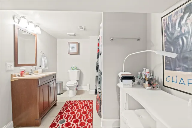 a bathroom with a sink double vanity and a toilet