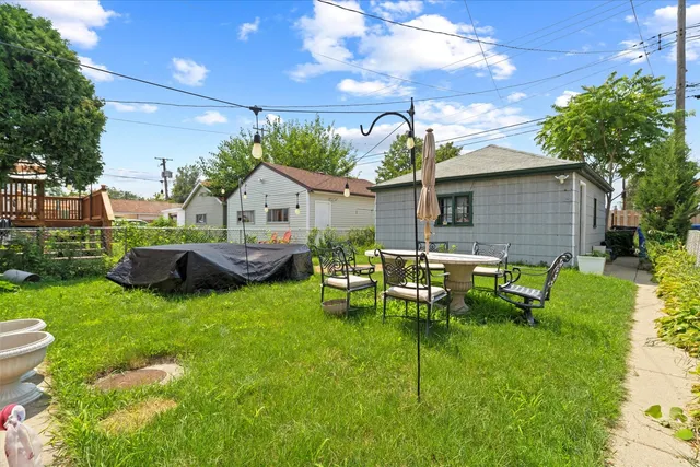a front view of house with a garden and patio